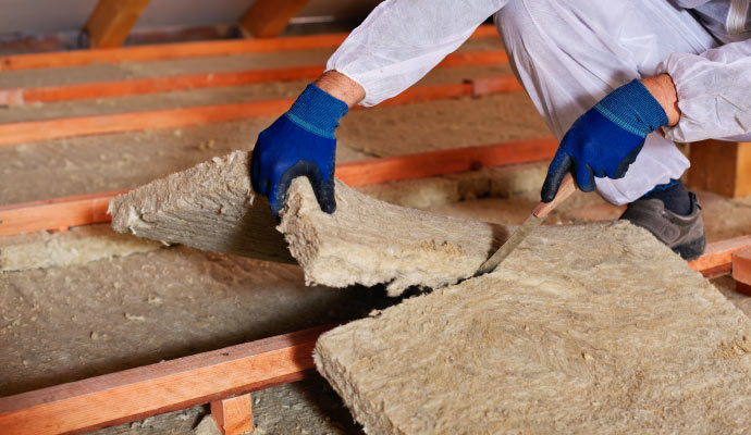 A person installing insulation