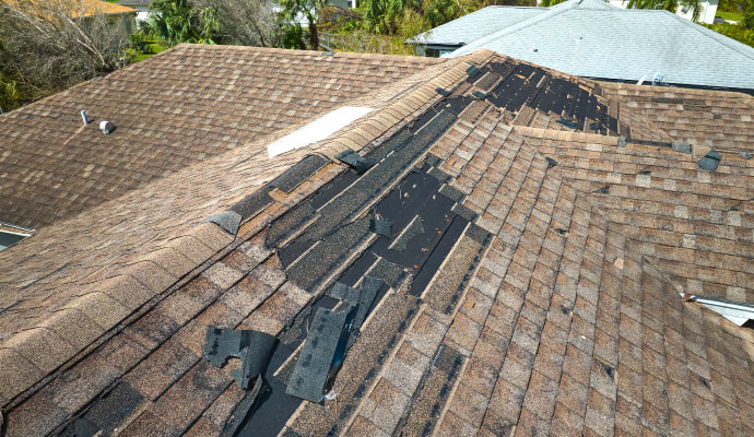 A roof with significant damage to the shingles