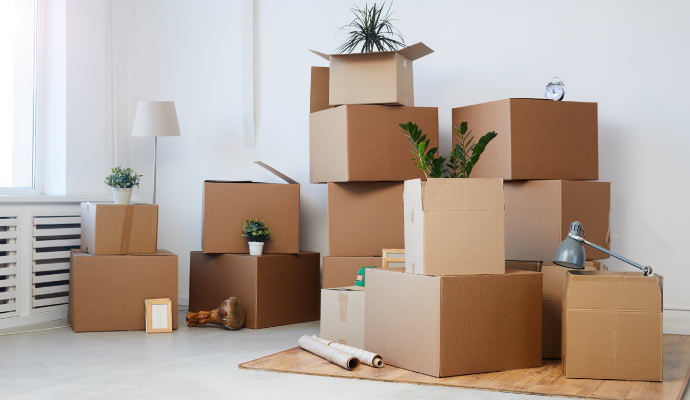 Room filled with stacked moving boxes