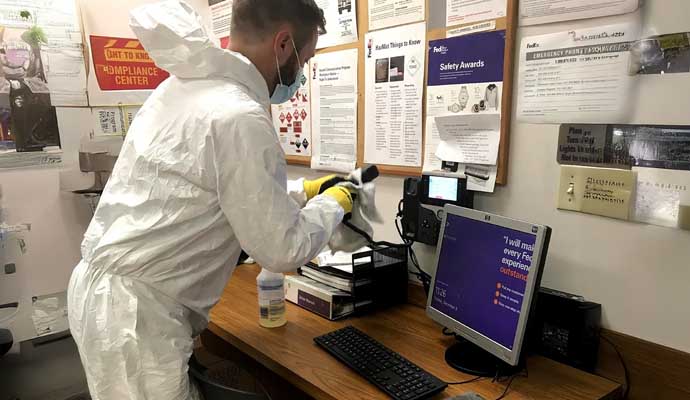 Person providing disinfecting services with equipment