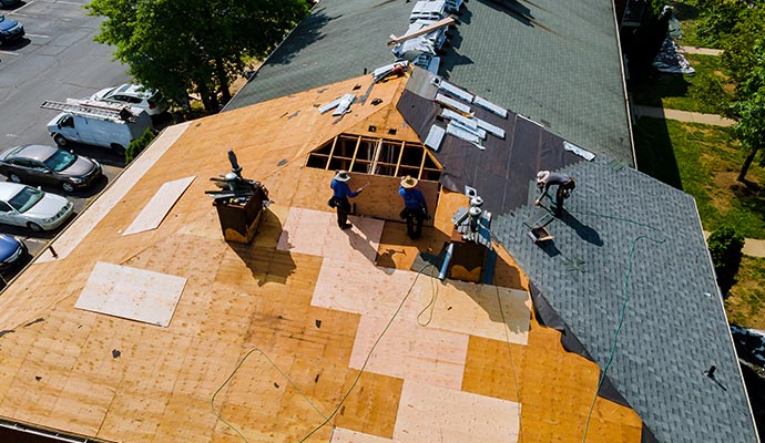 Person repairing damaged roof